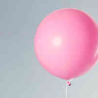 Pink balloon with blue background