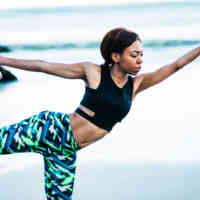 Woman performing yoga on the beach
