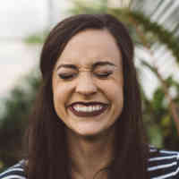 Woman smiling and closing her eyes with nature background