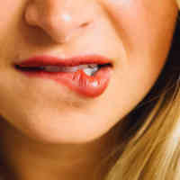 Woman biting lip with red lipstick