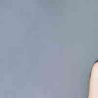 Woman smiling and holding Schmidt's Lavender and Sage deodorant near her mouth