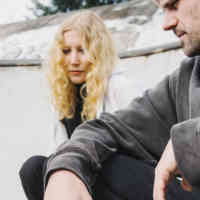 A woman and a man in a skateboard park
