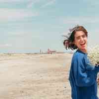 Girl on Beach with Flowers