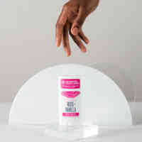 woman hand reaching for schmidt's rose + vanilla signature deodorant stick with magnesium