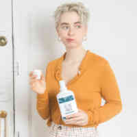 Girl swishing with Schmidt's Tea Tree+Ginger Mouthwash