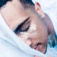 man's face covered in glitter