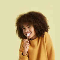Cute kid brushing teeth with Schmidt's Kids Toothpaste in Coconut+Pineapple