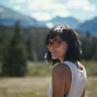 Woman with sunglasses in a national park on a sunny day