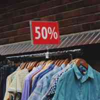 vintage clothing rack marked 50 percent off