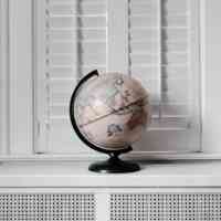 Beige world globe in a room
