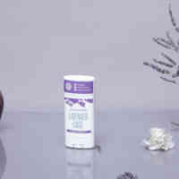 Schmidt's Natural Deodorant Lavender + Sage Stick on a purple background with lavender herbs